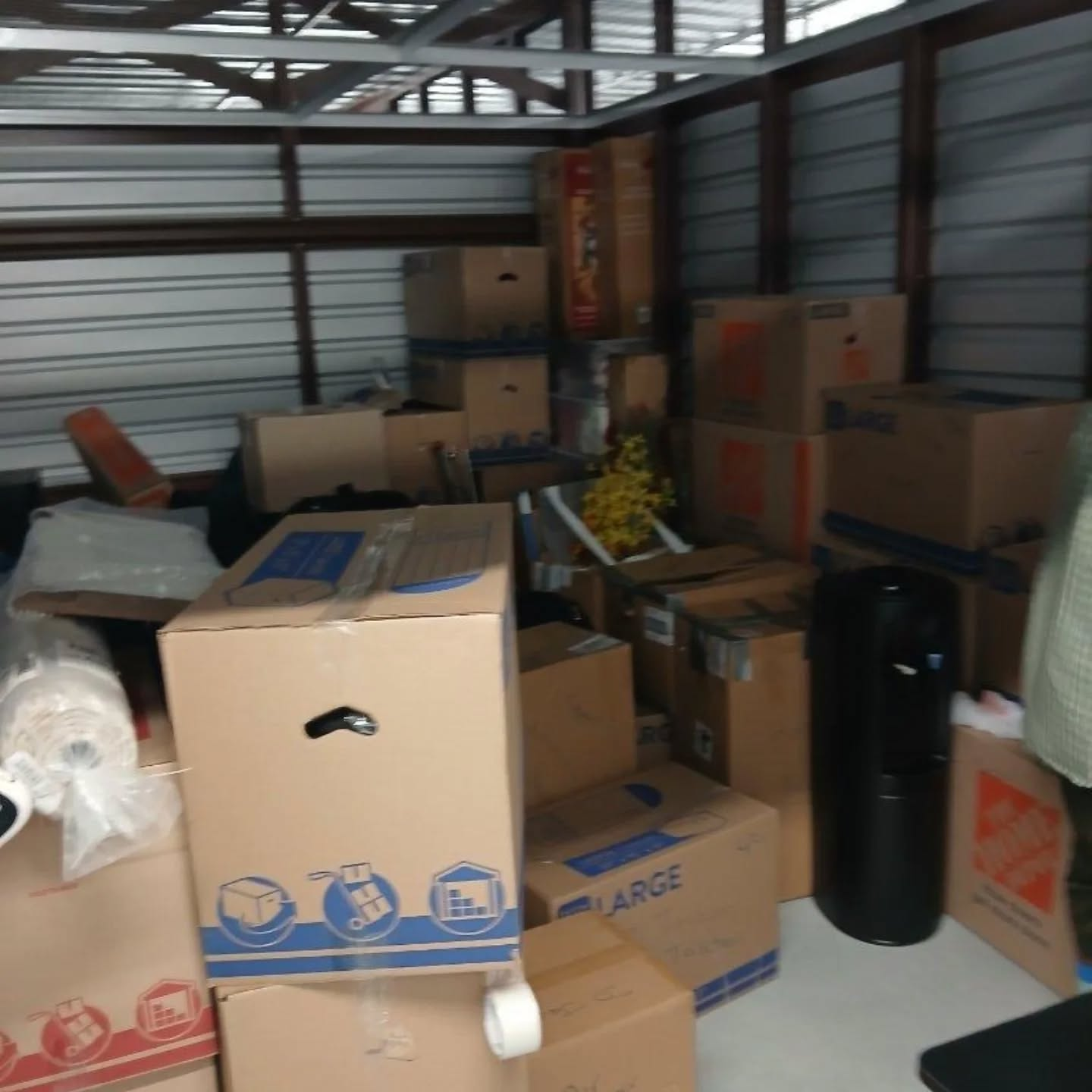 Storage unit organized with packed moving boxes